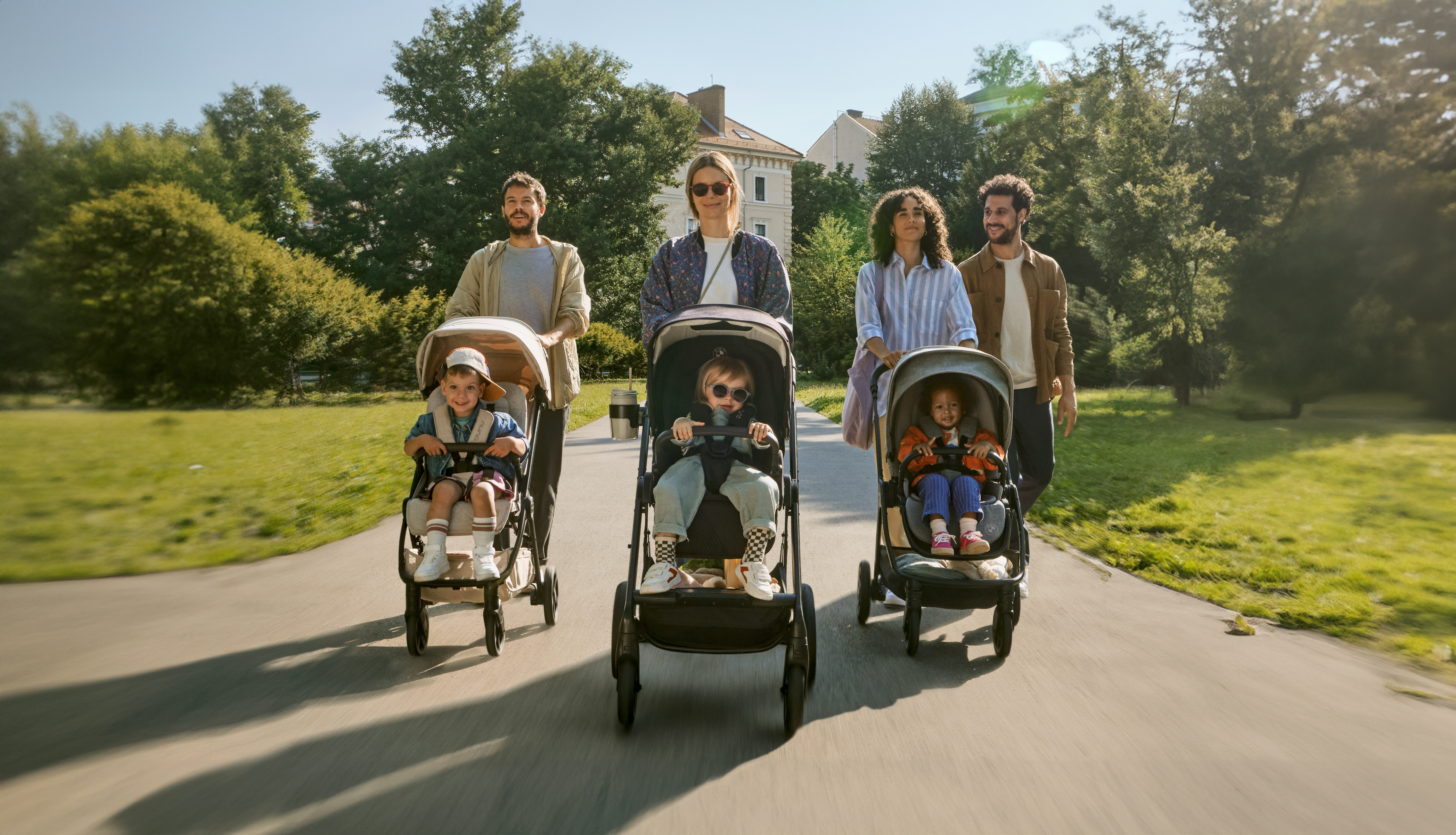 3 families with their kids pushing baby strollers